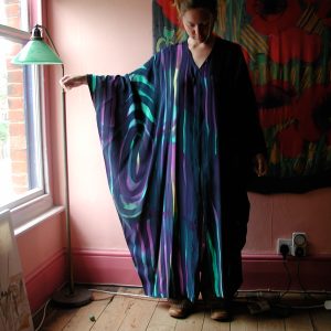 Model wearing hand-painted silk kaftan in crepe de chine